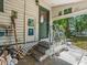 Inviting front porch with vintage metal railing, showcasing the entryway with green trim at 485 E Stanford St, Bartow, FL 33830
