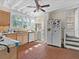 Cozy kitchen featuring brick floors, a ceiling fan, and bright natural light from multiple windows at 485 E Stanford St, Bartow, FL 33830