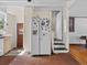 Open kitchen space featuring white appliances, brick floors, and multiple doorways at 485 E Stanford St, Bartow, FL 33830