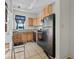 Modest kitchen features wood cabinets and includes black appliances at 485 E Stanford St, Bartow, FL 33830