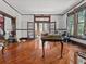 Expansive living room featuring original hardwood floors, detailed trim, and many windows at 485 E Stanford St, Bartow, FL 33830