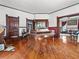 Spacious living room boasts hardwood floors, an antique fireplace mantel, and ample natural light at 485 E Stanford St, Bartow, FL 33830