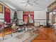 Bright living room featuring hardwood floors, large windows, and classic details at 485 E Stanford St, Bartow, FL 33830