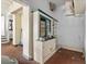 View of a pantry with a display cabinet, open shelving, and brick floors at 485 E Stanford St, Bartow, FL 33830