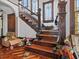 Close-up shot of the home's staircase that is richly detailed in original wood trim at 485 E Stanford St, Bartow, FL 33830