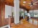 Sunroom with wood walls, several windows, and hardwood floors at 485 E Stanford St, Bartow, FL 33830
