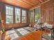 Charming sunroom featuring wood paneling, a wood floor, and large windows bringing in lots of light at 485 E Stanford St, Bartow, FL 33830