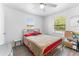 Bright bedroom features a large window, neutral walls, and a comfortable bed frame at 652 N Jackson St, Eagle Lake, FL 33839
