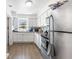 A well-lit kitchen featuring white cabinets, stainless steel appliances, and a window overlooking the yard at 652 N Jackson St, Eagle Lake, FL 33839