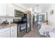 Open-concept kitchen with stainless steel appliances seamlessly connected to the living area at 652 N Jackson St, Eagle Lake, FL 33839