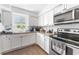 The updated kitchen features white cabinets and stainless steel appliances at 652 N Jackson St, Eagle Lake, FL 33839