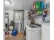 Functional laundry room with modern washer and dryer, wire shelving, and exterior access at 652 N Jackson St, Eagle Lake, FL 33839