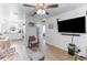 Inviting living room with modern ceiling fan and a wall-mounted television and neutral paint at 652 N Jackson St, Eagle Lake, FL 33839