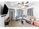 Inviting living room with a ceiling fan, large windows and wood-look flooring at 652 N Jackson St, Eagle Lake, FL 33839
