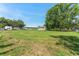 Spacious grassy yard with an outbuilding, offering ample room for outdoor activities at 652 N Jackson St, Eagle Lake, FL 33839