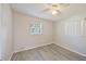 A bright bedroom features new laminate flooring, fresh paint, a ceiling fan, and lots of natural light at 728 Trenton Rd, Lakeland, FL 33815