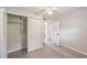Well-lit room featuring gray laminate flooring, a ceiling fan, closet, and doors to other rooms at 728 Trenton Rd, Lakeland, FL 33815