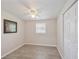 A bright bedroom features new laminate flooring, fresh paint, a ceiling fan, and lots of natural light at 728 Trenton Rd, Lakeland, FL 33815