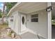 Inviting front entrance of a home showcasing a decorative door, modern lighting, and tidy landscaping at 728 Trenton Rd, Lakeland, FL 33815