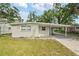 Charming single-story home with a covered carport and well-maintained front lawn at 728 Trenton Rd, Lakeland, FL 33815