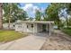 Well-maintained single-story home featuring a convenient covered carport and a tidy front yard at 728 Trenton Rd, Lakeland, FL 33815