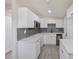 Modern kitchen featuring sleek cabinets, new backsplash, and appliances at 728 Trenton Rd, Lakeland, FL 33815