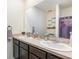 Bathroom featuring dual sinks, a large mirror, and a shower with a purple shower curtain at 3333 Costello Cir, Winter Haven, FL 33884