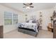 Bright bedroom with large window, ceiling fan, and tasteful decor at 3333 Costello Cir, Winter Haven, FL 33884