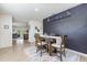 Elegant dining room with a stylish accent wall, wooden table, and neutral-toned rug at 3333 Costello Cir, Winter Haven, FL 33884