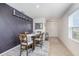 Well-lit dining room featuring a modern accent wall and a view to the entryway and kitchen at 3333 Costello Cir, Winter Haven, FL 33884