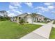 Well-maintained single-Gathering home with an inviting yellow front door and landscaped front yard at 3333 Costello Cir, Winter Haven, FL 33884