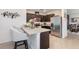 Modern kitchen with dark cabinetry, stainless steel appliances, and a breakfast bar at 3333 Costello Cir, Winter Haven, FL 33884