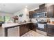 Well-lit kitchen with stainless steel appliances, ample counter space, and a view into the living area at 3333 Costello Cir, Winter Haven, FL 33884