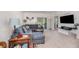 Comfortable living room with a plush sectional sofa and a sliding glass door to the patio at 3333 Costello Cir, Winter Haven, FL 33884