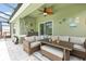 Relaxing outdoor patio area with cozy seating, ceiling fan, and charming decor for comfortable lounging at 3333 Costello Cir, Winter Haven, FL 33884