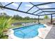 Inviting pool area featuring a tranquil water view, enclosed by a screen, and comfortable seating at 3333 Costello Cir, Winter Haven, FL 33884