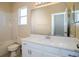 Neutral bathroom featuring a white vanity with a sink, toilet, tub, and shower with tile surround at 4526 Ficus Tree Rd, Kissimmee, FL 34758