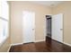Bedroom features hardwood floors, neutral paint, and large windows for natural light at 4526 Ficus Tree Rd, Kissimmee, FL 34758