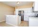 Bright kitchen features stainless steel appliances, white cabinets, and a breakfast bar at 4526 Ficus Tree Rd, Kissimmee, FL 34758