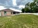 Expansive backyard with privacy fence, green grass, and screened patio at 6376 Sw 117Th Street Rd, Ocala, FL 34476