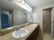 Bathroom vanity features dual sinks, generous countertop space, and large mirrors at 6376 Sw 117Th Street Rd, Ocala, FL 34476