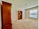 Spacious bedroom with a built-in bookshelf and neutral carpet at 6376 Sw 117Th Street Rd, Ocala, FL 34476