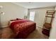 Cozy bedroom is tastefully decorated with unique furnishings and ample natural light at 6376 Sw 117Th Street Rd, Ocala, FL 34476