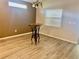 Cozy dining area featuring hardwood floors, a modern light fixture, and neutral paint scheme at 6376 Sw 117Th Street Rd, Ocala, FL 34476
