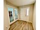 Welcoming entryway with elegant glass French doors and hardwood flooring at 6376 Sw 117Th Street Rd, Ocala, FL 34476