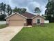Charming single-story home with a well-manicured lawn and an attached two-car garage at 6376 Sw 117Th Street Rd, Ocala, FL 34476