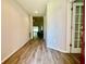 Bright hallway with wood floors leading into the home with an open floorplan at 6376 Sw 117Th Street Rd, Ocala, FL 34476