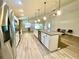 Bright kitchen features stainless steel appliances, granite countertops, and pendant lighting at 6376 Sw 117Th Street Rd, Ocala, FL 34476