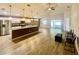 Open-concept living space features hardwood floors, a ceiling fan, and sliding glass doors at 6376 Sw 117Th Street Rd, Ocala, FL 34476