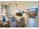 Open-concept living room with eat-in kitchen, island, and modern decor with lots of natural light at 6376 Sw 117Th Street Rd, Ocala, FL 34476